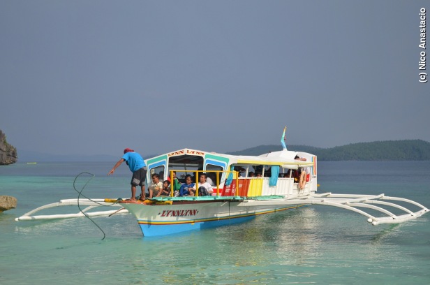 Boat full of tourists who will visit the Bitaog Beach